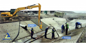 An excavator arm being used to place concrete in lieu of a shotcrete crew